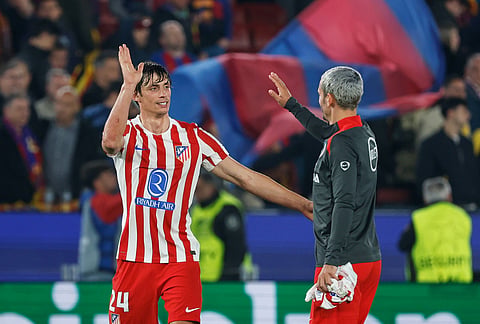 Atletico Madrid's Robin Le Normand, left, and Atletico Madrid's Antoine Griezmann celebrate their victory at the Champions League quarterfinal first leg soccer match between Barcelona and Atletico Madrid in Barcelona, Spain.