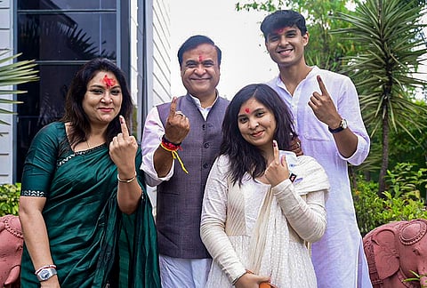 Assam Chief Minister Himanta Biswa Sarma and his family members show their ink-marked fingers after casting votes at Jalukbari constituency during the state Assembly elections, in Kamrup district. 