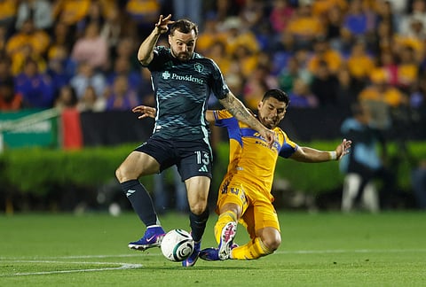 Jesus Angulo of Mexico's Tigres, right, challenges Jordan Morris of the United States' Seattle Sounders during a CONCACAF Champions Cup quarterfinal first leg soccer match in Monterrey, Mexico.