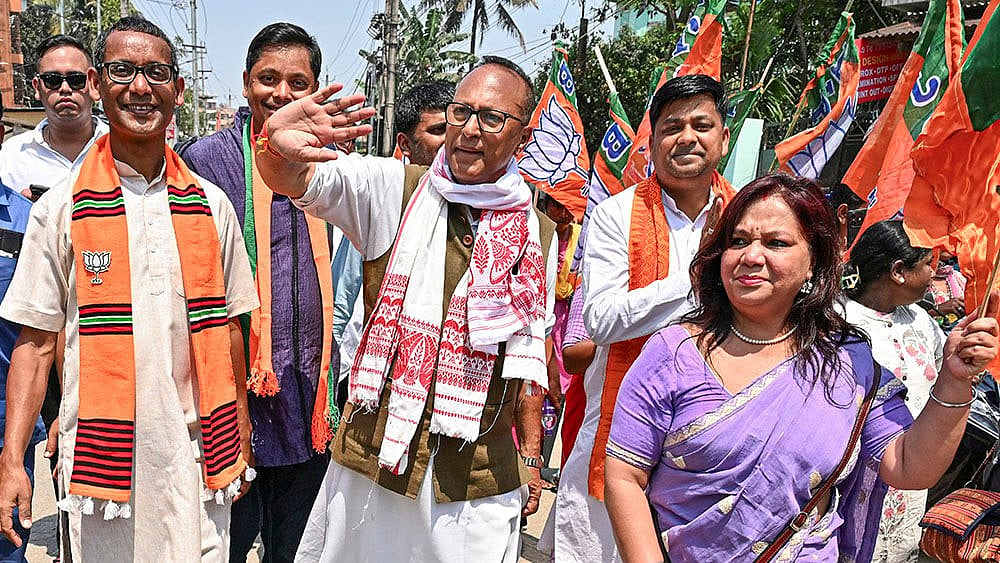 | Photo: PTI : BJP candidate for Dispur constituency, Pradyut Bordoloi, centre, greets supporters during the last day of election campaign ahead of the Assam Assembly Election, at Panjabari in Guwahati.
