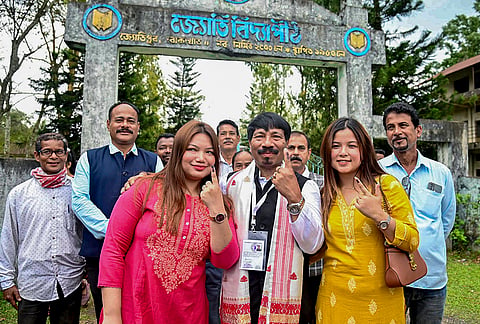 Asom Gana Parishad (AGP) President and candidate from Bokakhat constituency, Atul Bora, centre, show his ink-marked finger after casting a vote in the Assam Assembly elections, at a polling station, in Golaghat district.