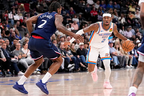Oklahoma City Thunder guard Shai Gilgeous-Alexander, right, tries to get past Los Angeles Clippers forward Kawhi Leonard during the first half of an NBA basketball game in Inglewood, Calif.