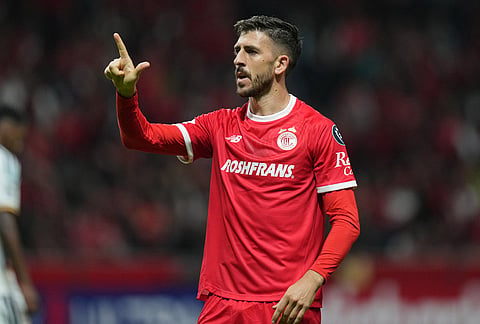 Paulinho of Mexico's Toluca celebrates scoring his side's second goal against the United States' LA Galaxy during a CONCACAF Champions Cup quarterfinal first leg soccer match in Toluca, Mexico.
