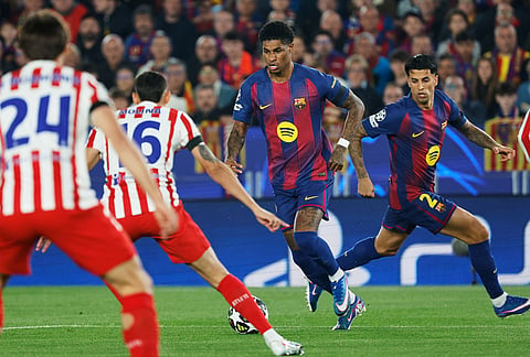 Barcelona's Marcus Rashford, centre, in action during the Champions League quarterfinal first leg soccer match between Barcelona and Atletico Madrid in Barcelona, Spain.