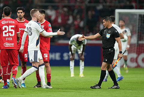 Marco Reus of the United States' LA Galaxy, left, shakes hands with a referee at the end of a CONCACAF Champions Cup quarterfinal first leg soccer match in Toluca, Mexico.