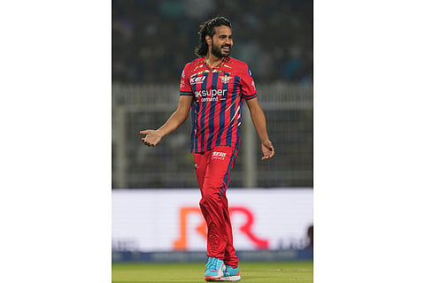 Lucknow Super Giants' Digvesh Rathi celebrates the wicket of Kolkata Knight Riders' captain Ajinkya Rahane during the Indian Premier League cricket match between Kolkata Knight Riders and Lucknow Super Giants in Kolkata, India