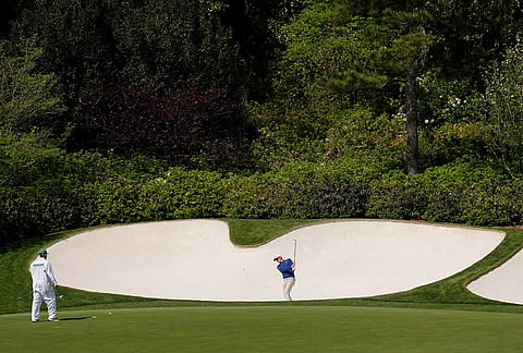 Jacob Bridgeman hits from the bunker on the 13th hole during a practice round ahead of the Masters golf tournament at the Augusta National Golf Club, in Augusta, Georgia.