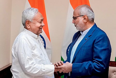 Vice President and Rajya Sabha Chairman CP Radhakrishnan greets Bihar Chief Minister Nitish Kumar as the latter takes oath as a member of the House during a ceremony at the former's chamber at the Parliament House complex, in New Delhi. 