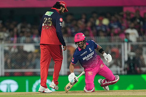 Rajasthan Royals' Dhruv Jurel reacts after being hit by a ball during the Indian Premier League cricket match between Royal Challengers Bengaluru and Rajasthan Royals in Guwahati, India.