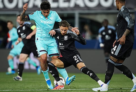 Aston Villa's Matty Cash and Bologna's Santiago Castro, left, in action during the Europa League soccer match between Bologna and Aston Villa in Bologna, Italy.