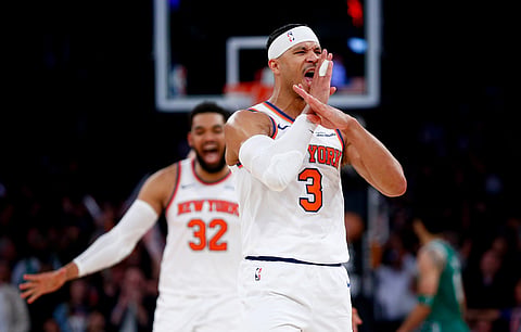 New York Knicks guard Josh Hart (3) reacts after making a 3-point basket in the final minute of an NBA basketball game against the Boston Celtics in New York.