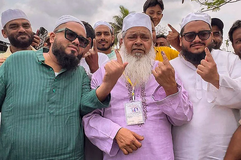 All India United Democratic Front (AIUDF) president and candidate from Binnakandi constituency, Maulana Badruddin Ajmal, shows his ink-marked finger after casting a vote in the Assam Assembly elections, in Binnakandi. - Photo: PTI