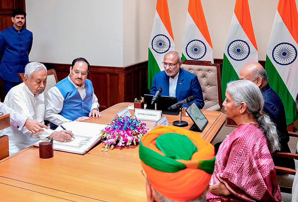 Vice President and Rajya Sabha Chairman CP Radhakrishnan administers oath to Bihar Chief Minister Nitish Kumar as a member of the House during a ceremony at the former's chamber at the Parliament House complex, in New Delhi. Union Ministers JP Nadda and Nirmala Sitharaman are also seen.  - | Photo: @CPR_VP/X via PTI