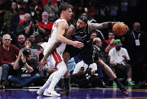 Toronto Raptors' Brandon Ingram, right, protects the ball from Miami Heat's Pelle Larsson (9) during second half NBA basketball action in Toronto.