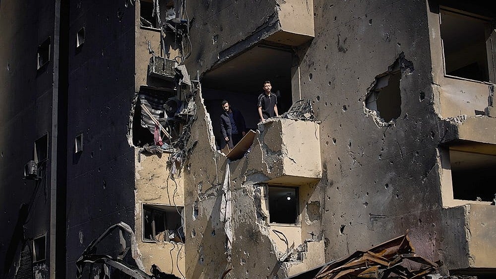Photo: AP/Emilio Morenatti : Men inspect the damage to their home destroyed in an Israeli airstrike a day earlier in Beirut, Lebanon, Thursday, April 9, 2026. 