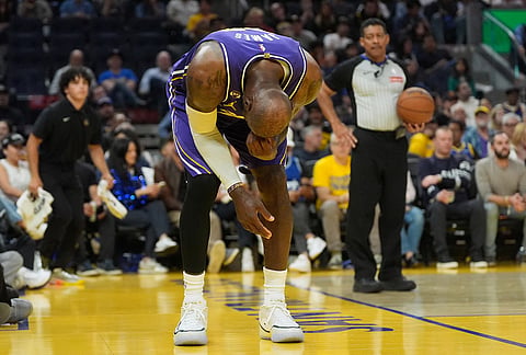 Los Angeles Lakers forward LeBron James reacts during the second half of an NBA basketball game against the Golden State Warriors in San Francisco.