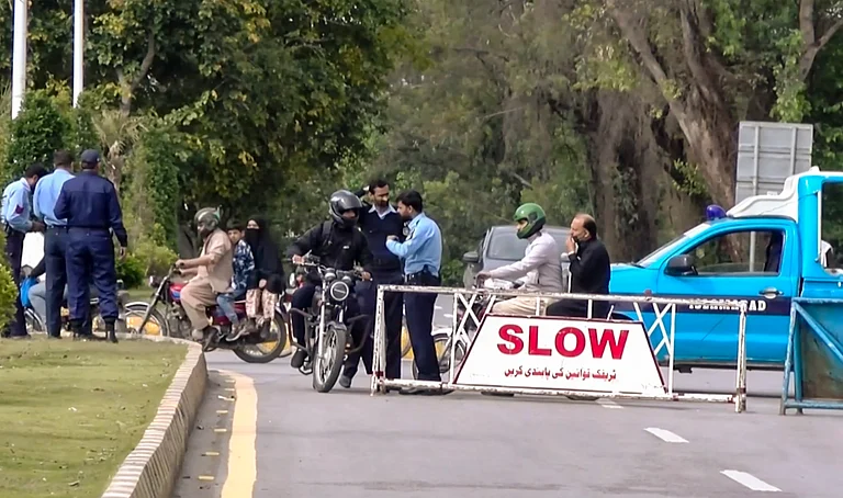 Islamabad: Security personnel check commuters at a barricade amid heightened security measures ahead of US-Iran talks, for which authorities have announced a two-day holiday, in Islamabad, Pakistan, Thursday, April 9, 2026. - PTI