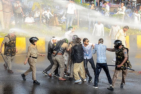 Police use water cannons to disperse NSUI workers during a protest against the BJP government over LPG cylinder prices, in Jabalpur.