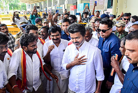 Actor and Tamilaga Vettri Kazhagam (TVK) chief Vijay being greeted by supporters upon his arrival at the airport, before heading to Karaikudi for an election campaign ahead of the Tamil Nadu Assembly polls, in Madurai.