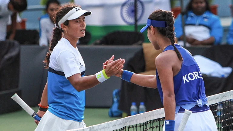 India's Ankita Raina, left, congratulates South Korea's Dayeon Back for winning a Billie Jean King Cup Asia/Oceania Group I women's singles match, in New Delhi. - PTI