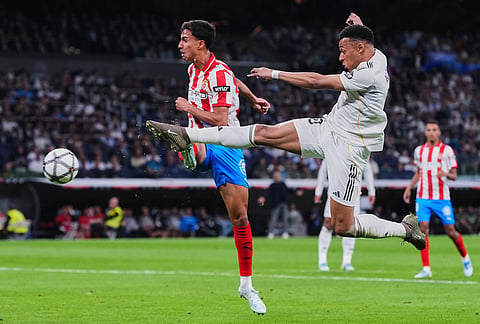 Real Madrid's Kylian Mbappe, right, fights for the ball with Girona's Vitor Reis during a Spanish La Liga soccer match between Real Madrid and Girona in Madrid, Spain.