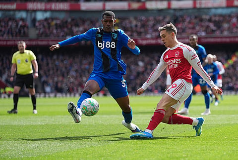 Arsenal's Leandro Trossard in action in front of Bournemouth's Adrien Truffert during the Premier League soccer match between Arsenal and Bournemouth in London, England.