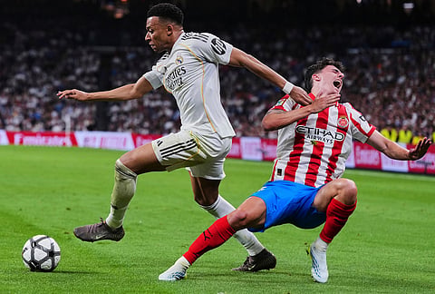 Real Madrid's Kylian Mbappe, left, fights for the ball with Girona's Alejandro Frances during a Spanish La Liga soccer match between Real Madrid and Girona in Madrid, Spain.