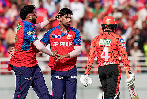 Punjab Kings' Shashank Singh, centre, with teammate celebrates after the wicket of Sunrisers Hyderabad's Travis Head during the Indian Premier League (IPL) 2026 cricket match between Punjab Kings and Sunrisers Hyderabad, at MYS Cricket Stadium in Mullanpur, New Chandigarh.