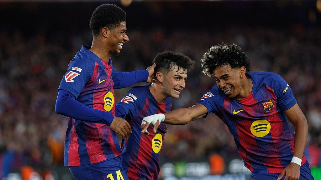Marcus Rashford, left, celebrates after scoring his side's fourth goal with Lamine Yamal, right, and Pedri during the La Liga match between Barcelona and Espanyol in Barcelona. - AP/Joan Monfort
