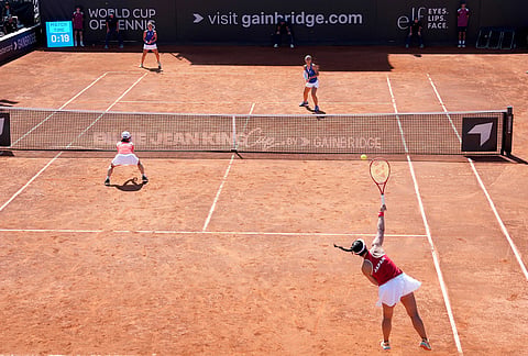 Japan's Eri Hozumi, bottom right, serves the ball during a doubles matche between Italy's Jasmine Paolini and Sara Errani against Japan's Eri Hozumi and Shuko Aoyama, during a Billy Jean King Cup match between Italy and Japan, in Velletri, Italy.