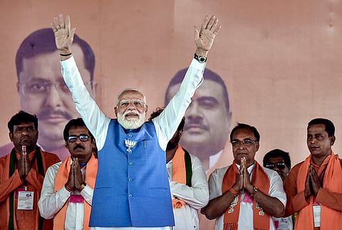 Prime Minister Narendra Modi greets during a public rally ahead of the West Bengal Assembly elections, in Jangipur, Murshidabad district, West Bengal.
