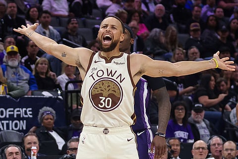Golden State Warriors guard Stephen Curry (30) reacts after being fouled but the basket didn't count during the second half of an NBA basketball game against the Sacramento Kings in Sacramento, Calif.