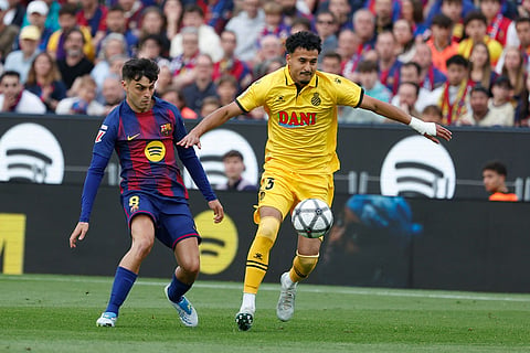 Barcelona's Pedri, left, and Espanyol's Omar El Hilali challenge for the ball during the Spanish La Liga soccer match between Barcelona and Espanyol in Barcelona, Spain.