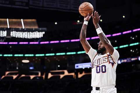 Phoenix Suns forward Royce O'Neale prepares to shoot against the Los Angeles Lakers during the first half of an NBA basketball game  in Los Angeles.