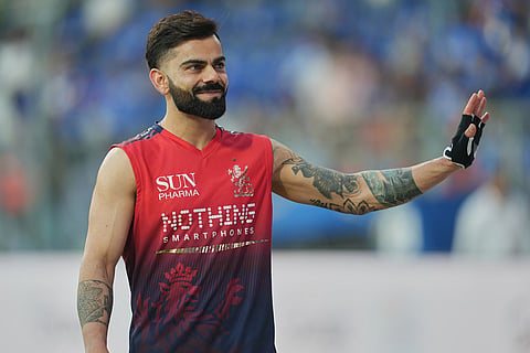 Royal Challengers Bengaluru's Virat Kohli waves to the crowd prior to start of the Indian Premier League cricket match between Mumbai Indians and Royal Challengers Bengaluru, in Guwahati, India.