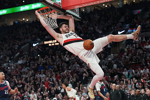 Portland Trail Blazers center Donovan Clingan dunks during the first half of an NBA basketball game against the Los Angeles Clippers in Portland, Ore.