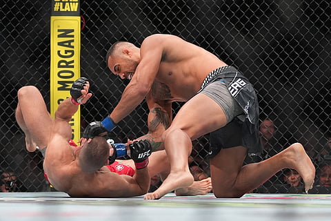 Carlos Ulberg, of New Zealand, strikes Jiri Prochazka, of Czechia, on his way to a TKO win in their light heavyweight title bout at a UFC 327 mixed martial arts event 2026, in Miami.