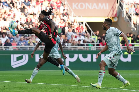 AC Milan's Rafael Leao shoots during the Serie A soccer match between AC Milan and Udinese, in Milan, Italy.