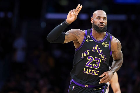 Los Angeles Lakers forward LeBron James gestures after making a basket against the Phoenix Suns during the first half of an NBA basketball game in Los Angeles.