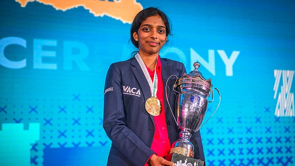 In this image taken on Sept. 15, 2025, India's GM Vaishali Rameshbabu poses with her trophy after winning the FIDE Women’s Grand Swiss 2025, in Samarkand, Uzbekistan. Vaishali made it to the women’s Candidates tournament after a hard-fought draw against former world champion Zhongyi Tan of China.  - | Photo: FIDE/Michal Walusza via PTI 