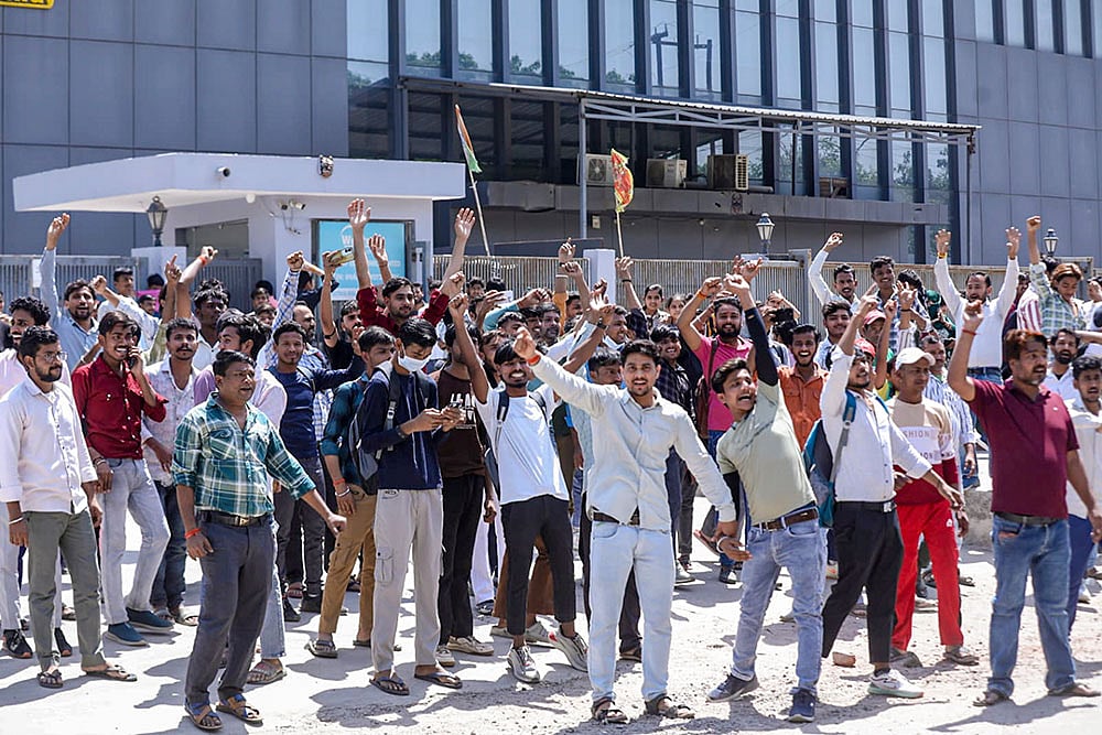 | Photo; PTI : Factory workers during a protest demanding a hike in wages