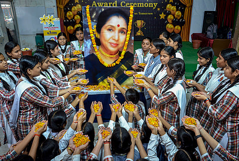 Students pay tributes to the late legendary playback singer Asha Bhosle, in Mirzapur.