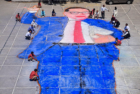 People create a portrait of BR Ambedkar on the eve of his birth anniversary, in Moradabad.