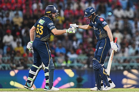Gujarat Titans' Jos Buttler congratulates captain Shubman Gill after his fifty runs during the Indian Premier League cricket match between Gujarat Titans and Lucknow Super Giants in Lucknow, India.
