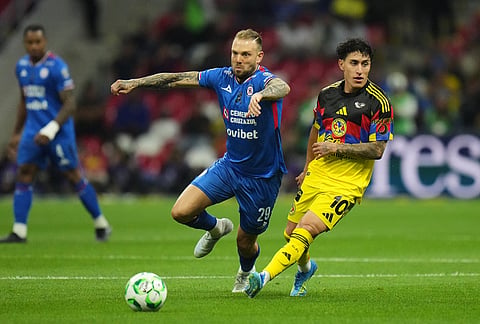 Cruz Azul's Rodolfo Rotondi, left, and America's Alejandro Zendejas go for the ball during a Mexican soccer league match in Mexico City.