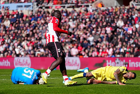 Sunderland's Brian Brobbey, centre, looks on after pushing Tottenham Hotspur's Cristian Romero, right, into Tottenham Hotspur goalkeeper Antonin Kinsky, left, during the Premier League soccer match between Sunderland and Tottenham Hotspur, in Sunderland, England.