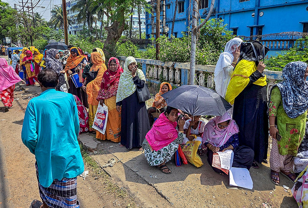 People gather to appeal before a tribunal over issues related to the Special Intensive Revision (SIR) of electoral rolls, ahead of the West Bengal Assembly elections, in Murshidabad, West Bengal. - | Photo: PTI