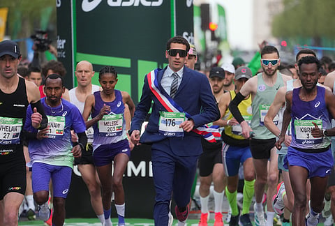 Competitors run the men's race of the Paris marathon, in Paris.