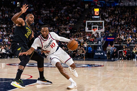 Los Angeles Clippers guard Darius Garland (10) drives against Golden State Warriors center Al Horford (20) during the first half of an NBA basketball game  in Inglewood, Calif.