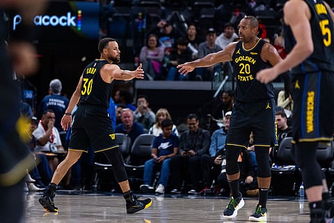 Golden State Warriors guard Stephen Curry (30) high fives Golden State Warriors center Al Horford (20) during the second half of an NBA basketball game in Inglewood, Calif.